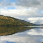 A Loch in Scotland with reflections tons of the mountain in the water