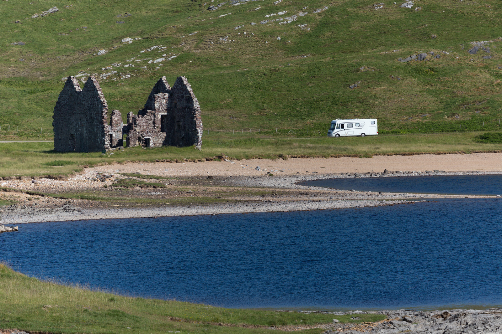 An Class Motorhome driving near Ardvreck Castle at Loch Assynt, Scotland