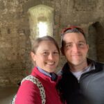 A Man and Woman pose together inside the ruins of a Castle