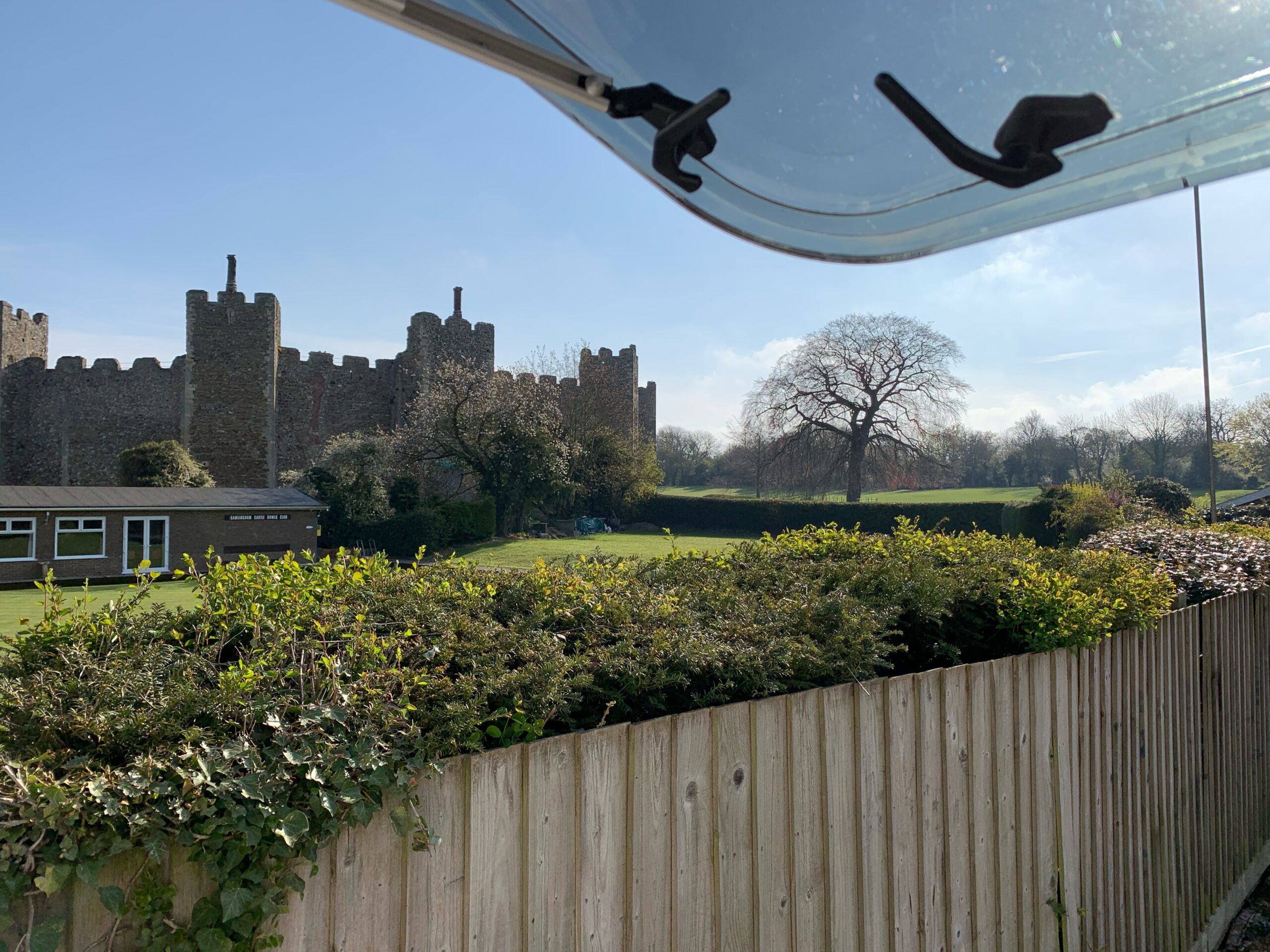 The view is out of an open motorhome window, looking out on to Framlingham Castle