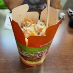 a picture of a Donner box. a carton willed with chicken kebab meat, salad and chips