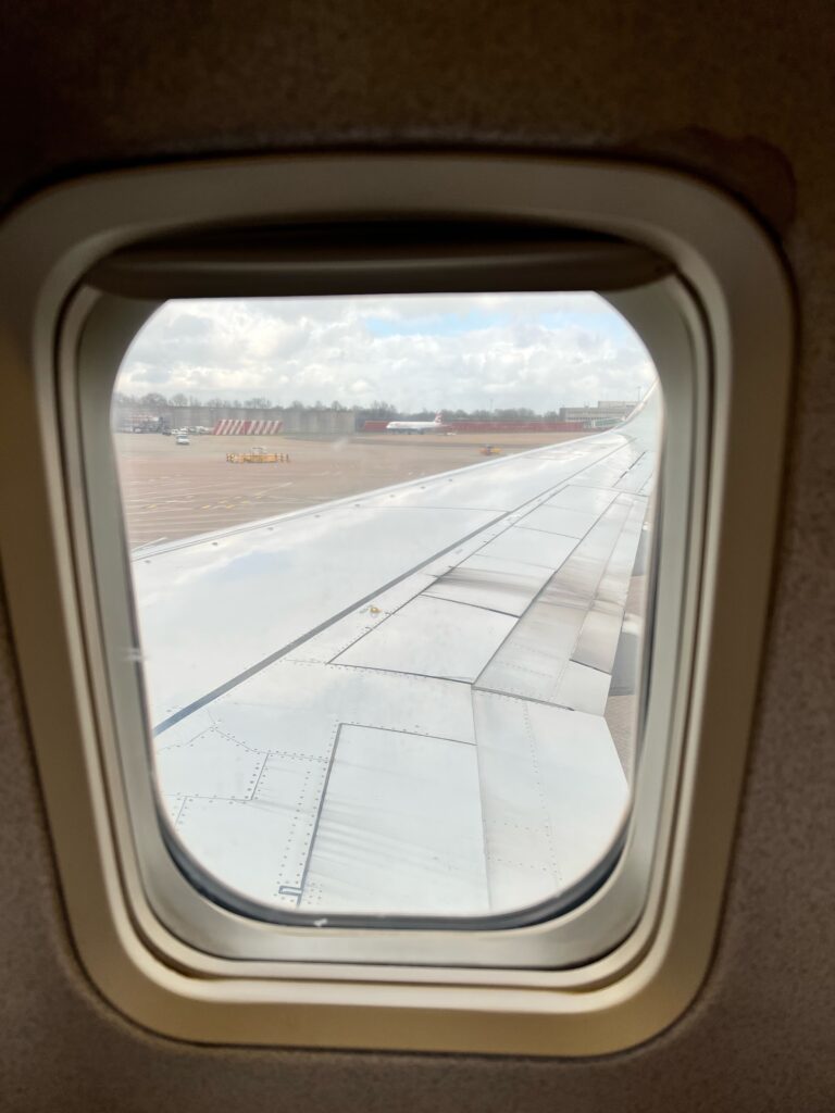 The picture is taken from inside a plane, form the window seat, looking out over the wing